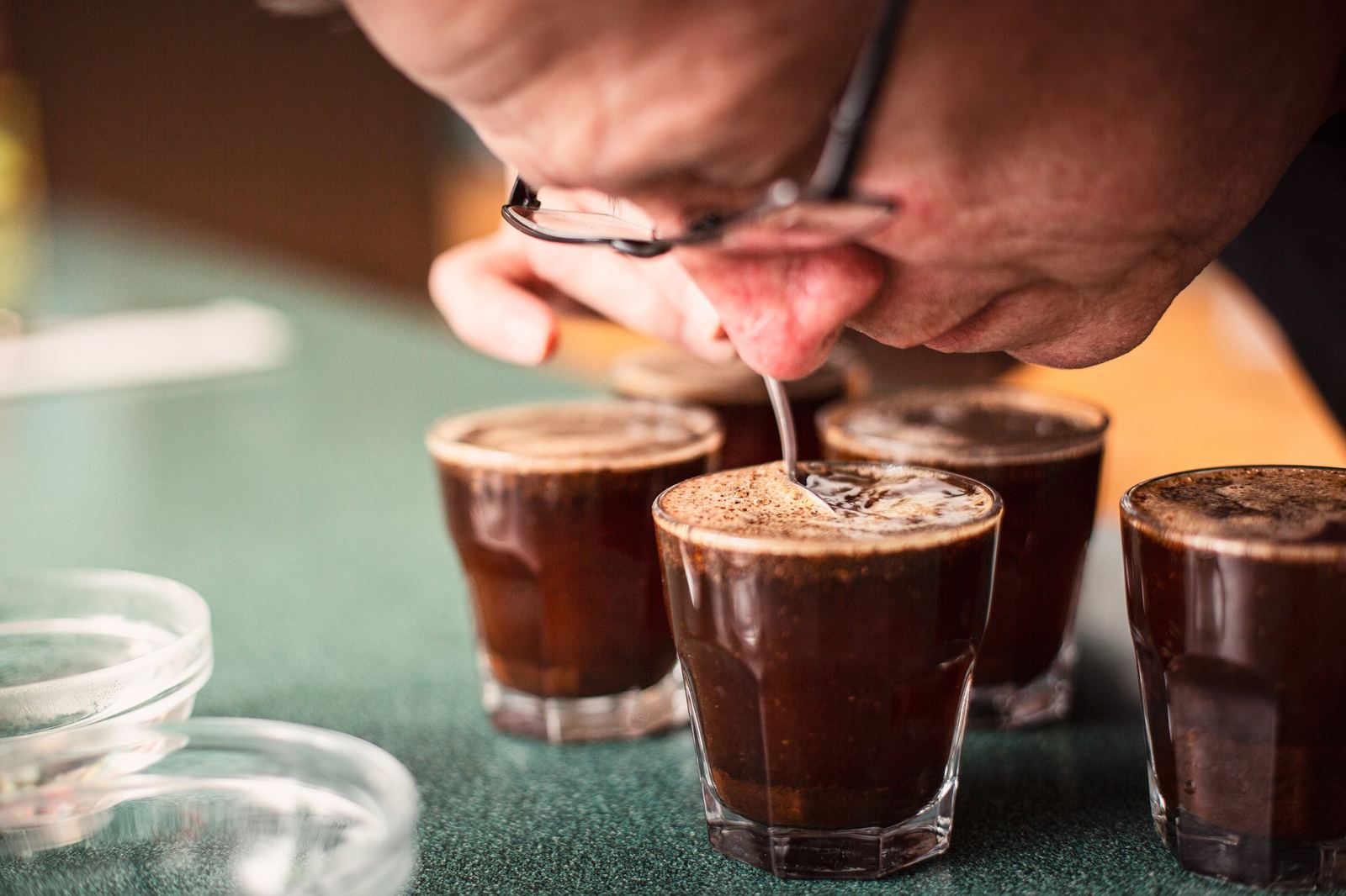 Three glasses of coffee being cupped and tasted