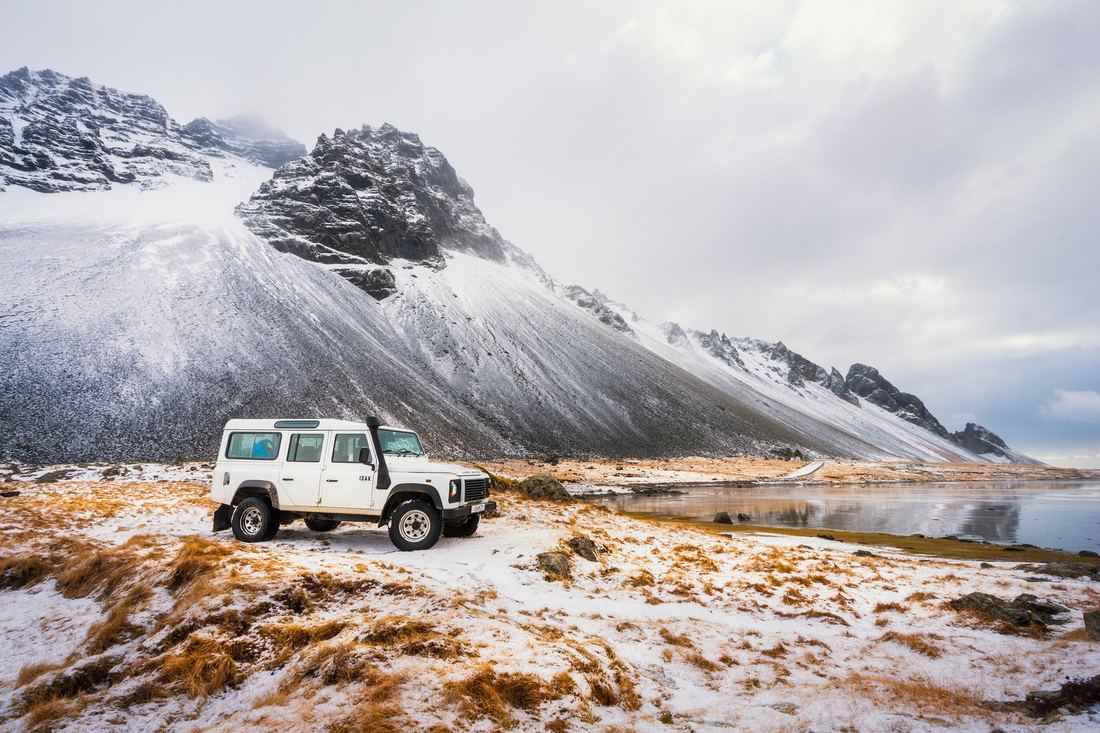 A Jeep parked on the snow line of Mauna Kea