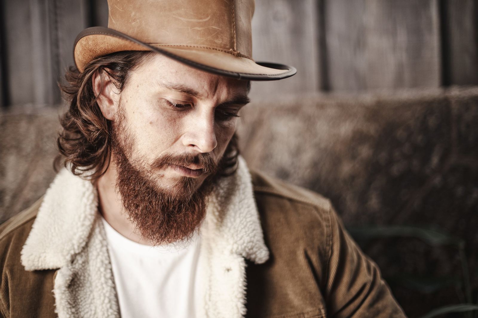 Portrait of a bearded musician in a wide brimmed hat