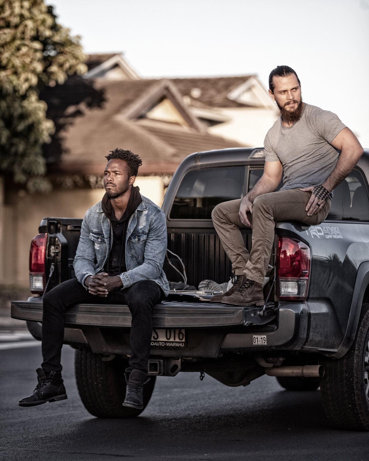 Two musicians beside a pickup truck